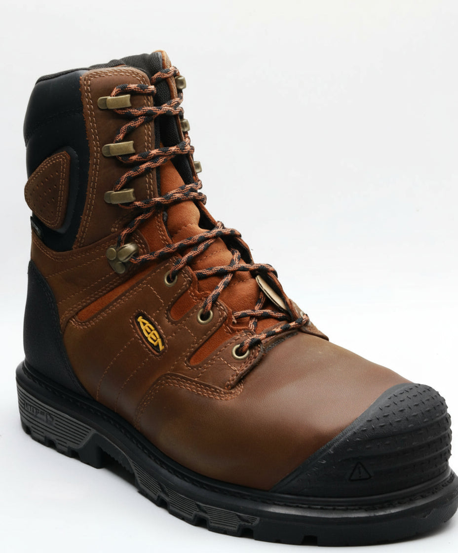 Brown work boot with black sole on a white background
