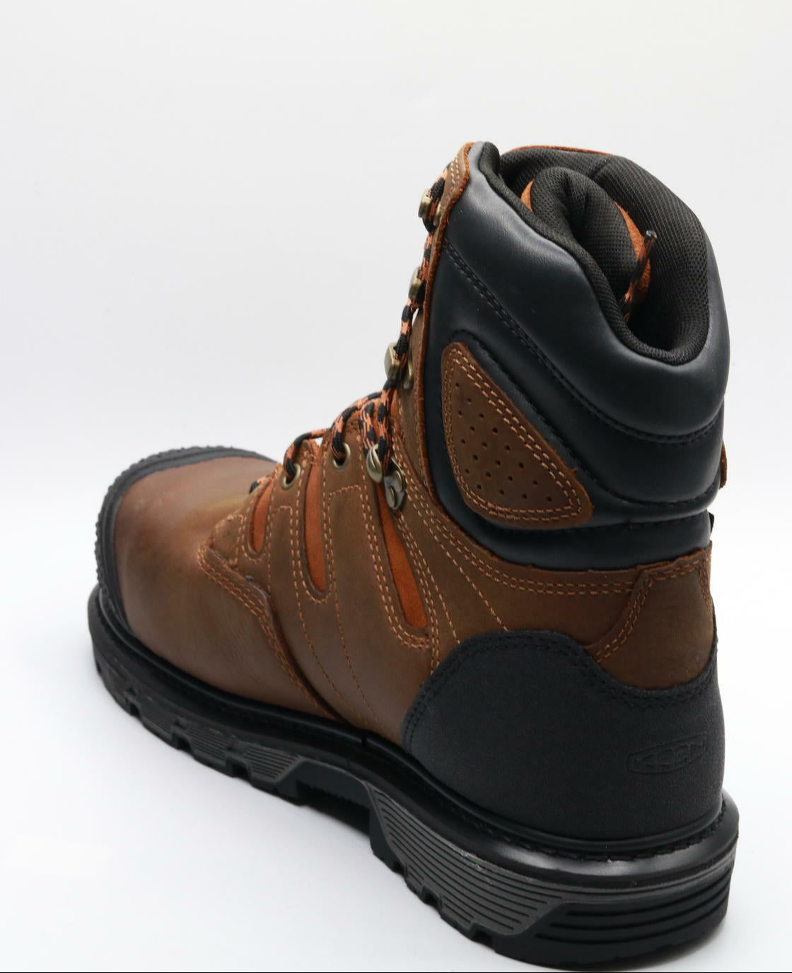 Brown leather boot with black sole on a white background