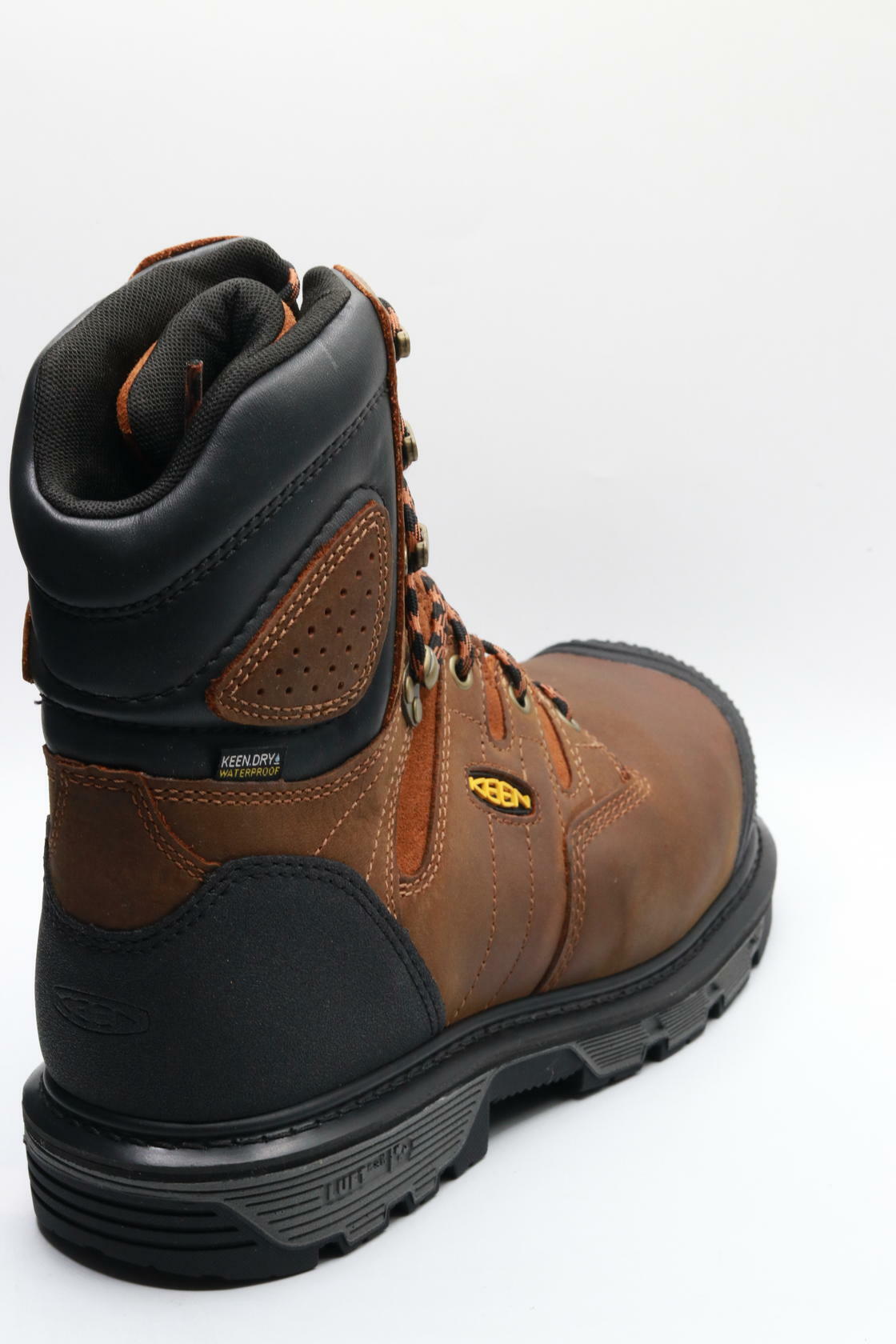 Brown and black work boot on a white background