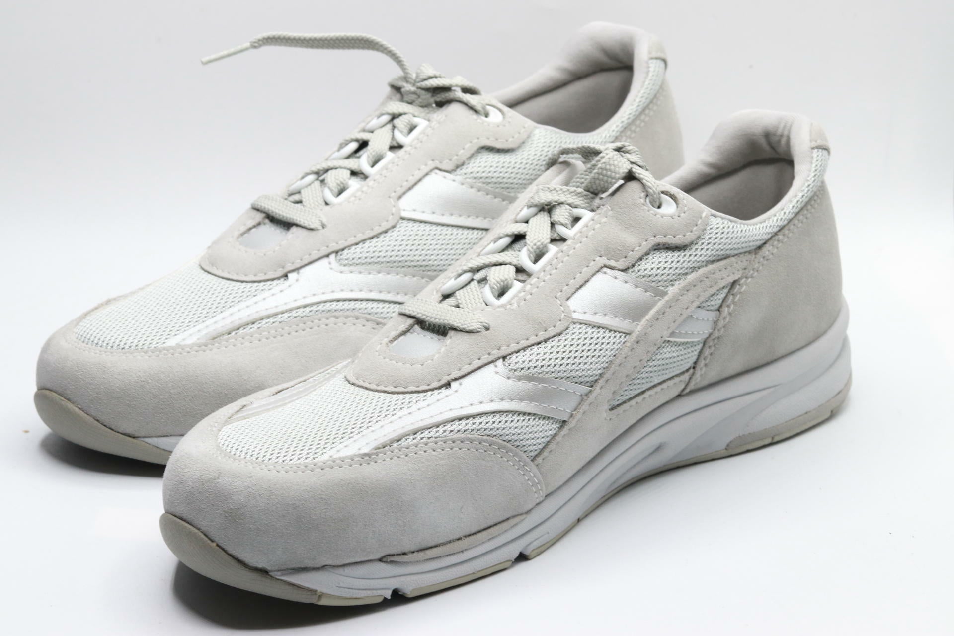 Pair of light gray sneakers on a white background